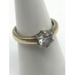 A Ladies 9ct gold ring set with a large clear stone. Ring size K. Also has engraved to the inside "I