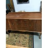 Antique sideboard supported on pedestal legs and ball with claw feet.