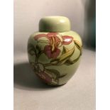 A Carlton Ware lidded jar depicting a floral design