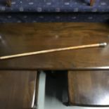 A Victorian walking cane/ swagger stick. Styled with a silver engraved top handle. Measures 90cm