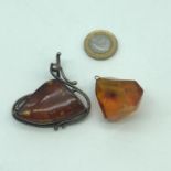 A Large silver 925 pendant set with a large amber stone, Together with a large chunk of natural