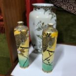 A pair of hand painted Japanese satsuma vases depicting an owl eating a cricket, with a six figure