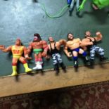 A Lot of 5 vintage WWF action figures which includes Hulk Hogan, Ultimate Warrior, Bush wackers