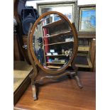 Antique mahogany framed dressing table oval mirror with bevel edging.