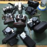 A Collection of vintage cameras which includes Pentax, Miranda, Ilford, Zenit and Olympus.