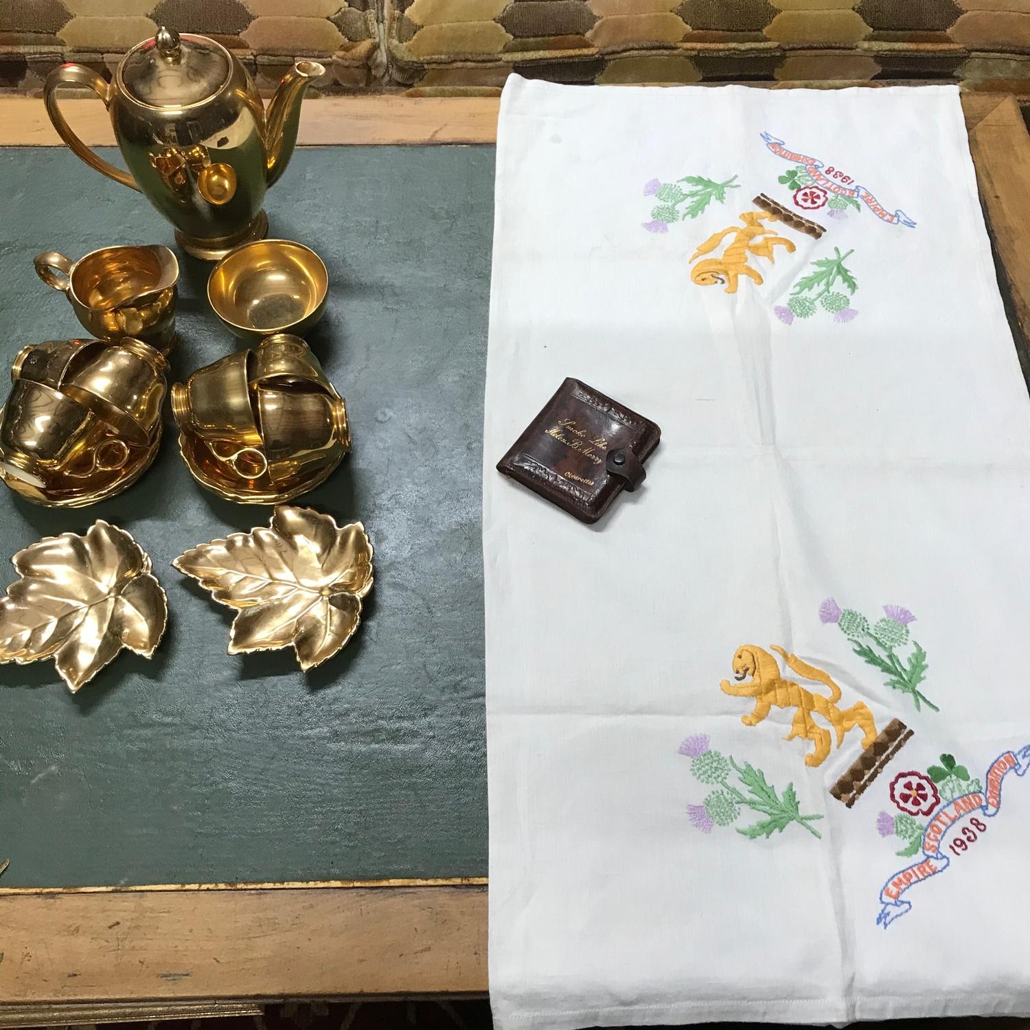 A 1938 Empire Scotland Exhibition table cloth, Cigarette case and Royal Winton gold plated porcelain