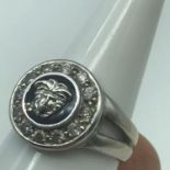 A 9ct white gold Altinbas ring designed in a Versace style. Showing Medusa like head surround by a