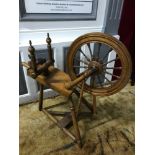A Victorian spinning wheel. In a working condition. One strap needs replaced to hold bobbin in