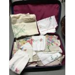 A Vintage travel case containing a large quantity of good quality linen, table clothes and various