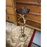 An original Art Nouveau cast metal stand fitted with a glass ash tray, produced by A.M.W 1925