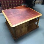 A Vintage teak Nathan coffee table, with under drawers and storage shelving. On castor feet.
