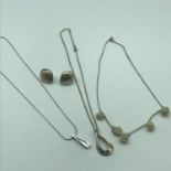 A Lot of three silver 925 necklaces with silver pendants. One pendant has a single diamond. Together