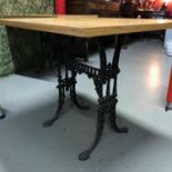 A Heavy cast iron base, solid light oak top table, Ideal for kitchen table. Measures 71x90x75cm