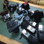 A Collection of vintage cameras which includes Yashica, Voigtlander, Olympus, Praktica and Minolta.