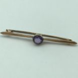 A Victorian 9ct gold ladies bar brooch set with a large round Amethyst stone. Weighs 3.33grams