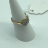 A Ladies 9ct gold ring set with .25ct diamond cluster setting. Weighs 2.32grams