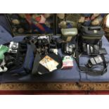 A Collection of cameras, video cameras and lenses. Includes Olympus OM30 35mm film SLR Camera with