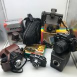 A Collection of vintage cameras and accessories. includes Praktica BX20 Camera, Coronet Cub, Coronet
