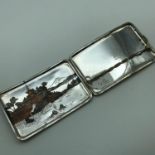 A Sterling silver Chinese pagoda scene cigarette case. Measures 8x12x1cm