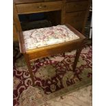 A Vintage piano stool with lift up lid.