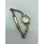 A Vintage ladies 14ct gold cased Hamilton watch with rolled gold strap. In a working condition.