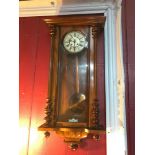 A Large Victorian long case wall clock with enamel face. Comes with key and pendulum, In a running