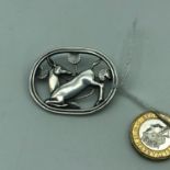 A Georg Jensen Sterling silver Kneeling Deer brooch.