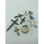 A Lot of 9 Religious pendants which includes 925 Sterling silver and green agate cross pendant