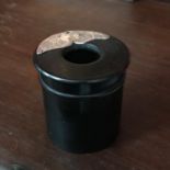 An ebony and London silver brush pot. Measures 6cm in height
