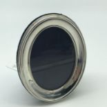 A Sheffield silver oval photo frame. Made by PJP. Measures 11x8.81.4cm