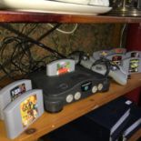 A Vintage Nintendo 64 console with two controllers and 9 games which includes Duke Nukem, Hardcore