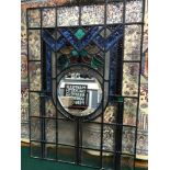 A Large stain glass window panel. Fitted with a round bevel edge mirror to the centre. Measures