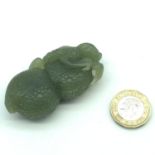 A Highly carved Chinese jade sculpture depicting a piece of fruit.