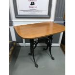 A Heavy cast iron base table fitted with a teak curved top, Could be used as a window table or