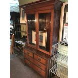 Antique two over two chest of drawers with a marriage of a bookcase top with fitted shelving and