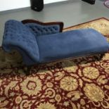 A Reproduction chaise longue designed in blue material, studded trims and mahogany wood.