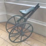 A Victorian childs trike parts. Has original metal and wooden wheels.