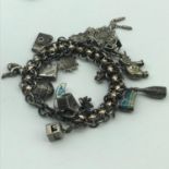 Antique silver charm bracelet with 20 silver charms and designed with gold tone diamond design round