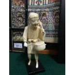 A Japanese Meiji period ivory Okimono drummer figure. Stands 16cm in height.