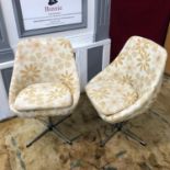 A Pair of retro swivel tub chairs with removable cushions.