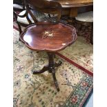 A reproduction mahogany pedestal wine table with brass inlay top