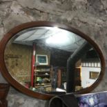 Edwardian mahogany oval mirror with bevel edging