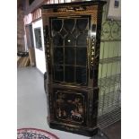 A Large oriental lacquered and hand painted corner cabinet. Very intricately painted with gilt