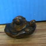 A Japanese hand carved netsuke Turtle Family hand singed by the artist.