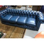A Vintage four seat Navy blue Chesterfield couch/settee. Measures 75x237x88cm