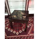 A Chinese black lacquered table hand painted with bird, floral and gilt designs.