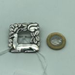 A Georg Jensen Sterling silver sitting deer & squirrel brooch.