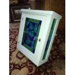 A Painted pine toilet cabinet set with stainglass front and sides.