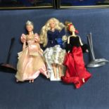 A lot of three vintage Barbie dolls, together with two figurine stands