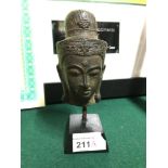 Antique bronze Thai Buddha head diety, Fixed to a wooden block base. Measures 15.5cm in height